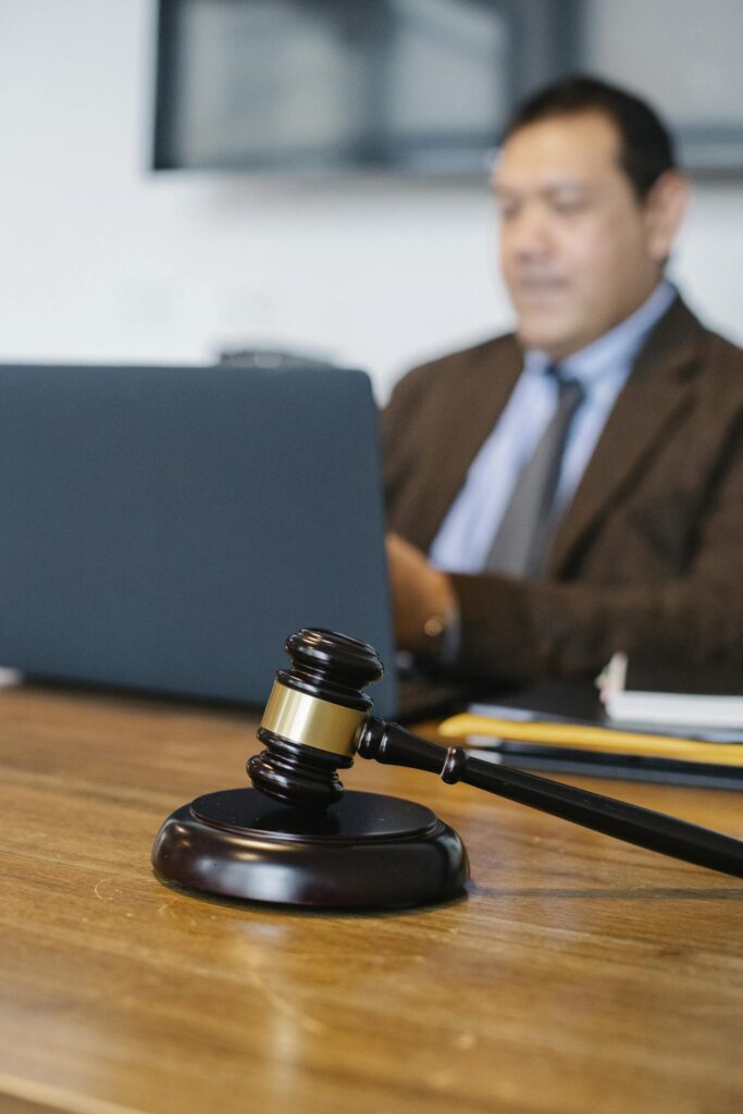 Male lawyer working on laptop in office